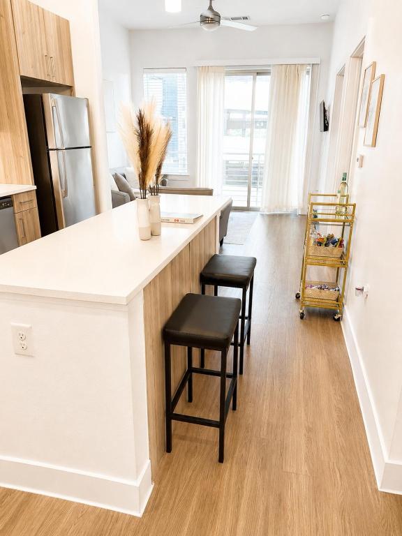 a kitchen with a white counter and stools at River Walk in San Antonio