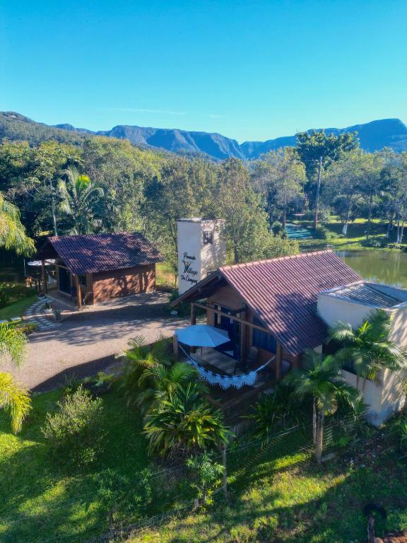 an aerial view of a house with a mountain in the background at Pousada Village dos Canyons in Praia Grande