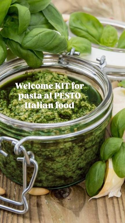 a jar of basil pesto next to a bunch of spinach at Al Quattro L'ovo Brusco Malpensa in Cardano al Campo
