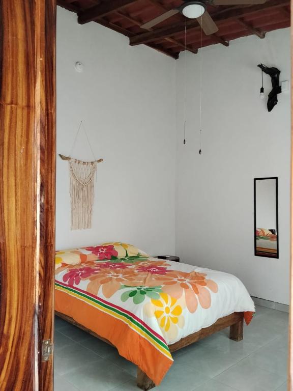 a bedroom with a bed with a colorful blanket at Casa ciruelo in Las Varas