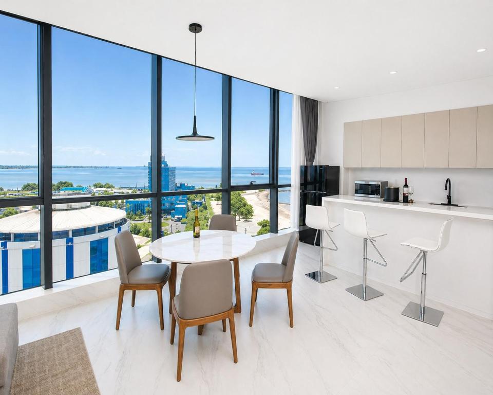 a kitchen and dining room with a table and chairs at Atlantic Suites Hotel in Georgetown