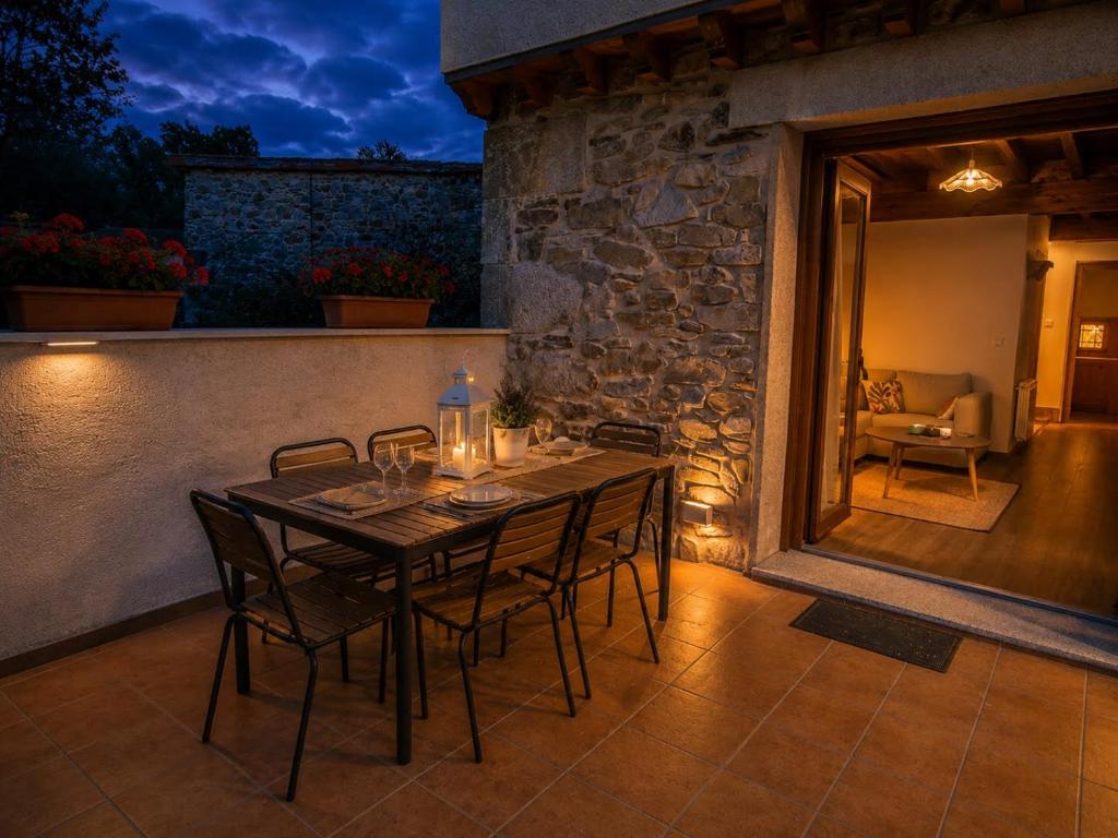 a dining table and chairs on a patio at night at Jaricha in Cabezas Altas