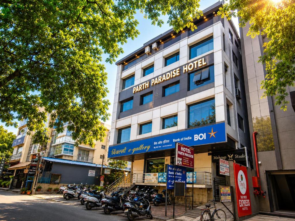 a building with motorcycles parked in front of it at Parth Paradise Hotel in Indore