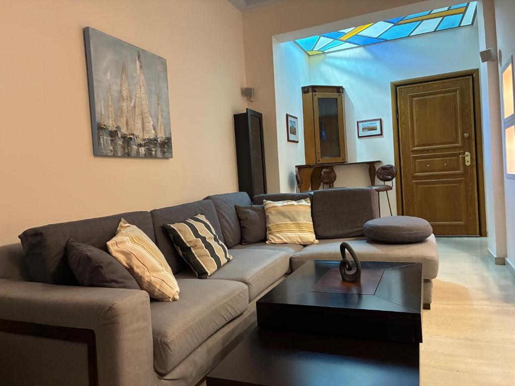 a living room with a couch and a table at Dream Home Thiva in Thiva