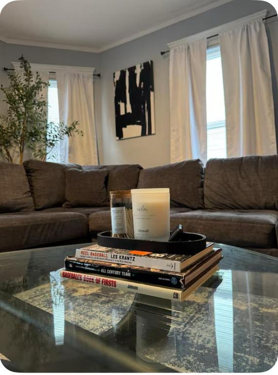 a living room with a coffee table with books on it at Charming Cozy Getaway in Oneonta