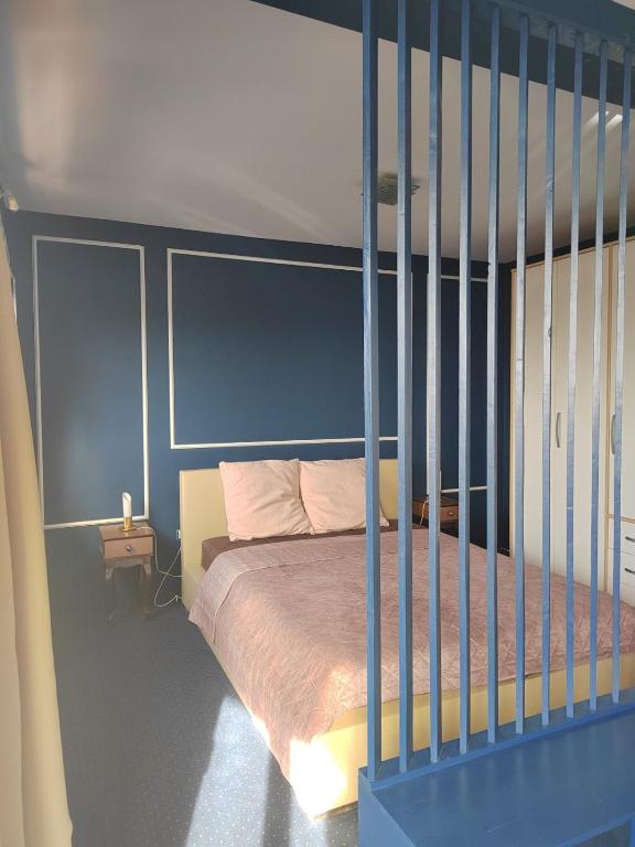 a bedroom with a bed with a blue head board at The VIEW in Belgrade