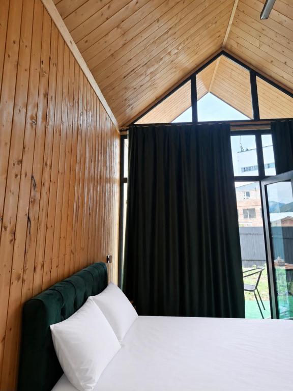 a bedroom with a bed and a window at AnArt rezort in Vanadzor
