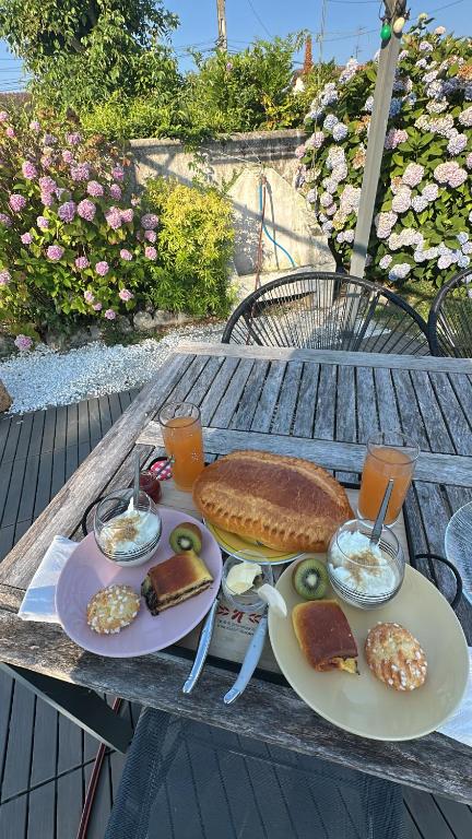 a table with two plates of food on it at Détente Normande in Branville