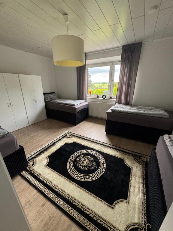 a room with two beds and a large window at Haus Teveren in Geilenkirchen