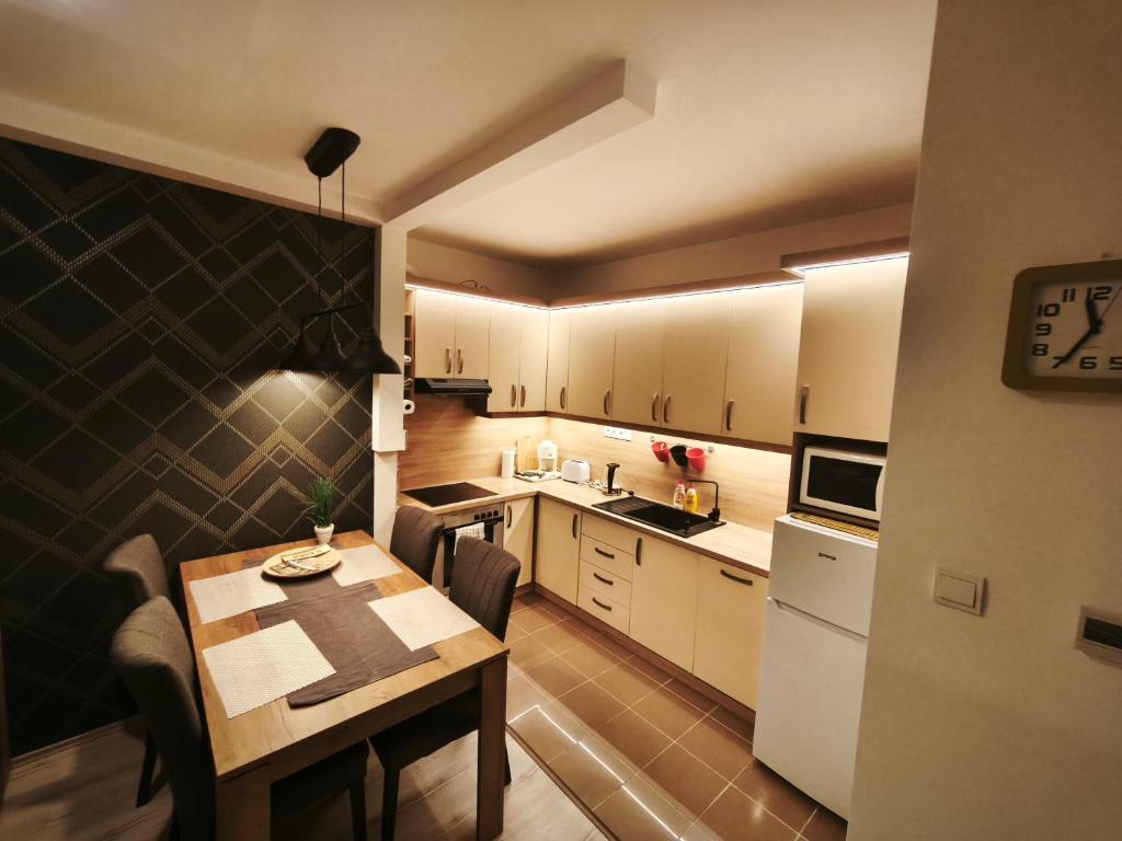 a small kitchen with a table and a dining room at Family Residence in Eger