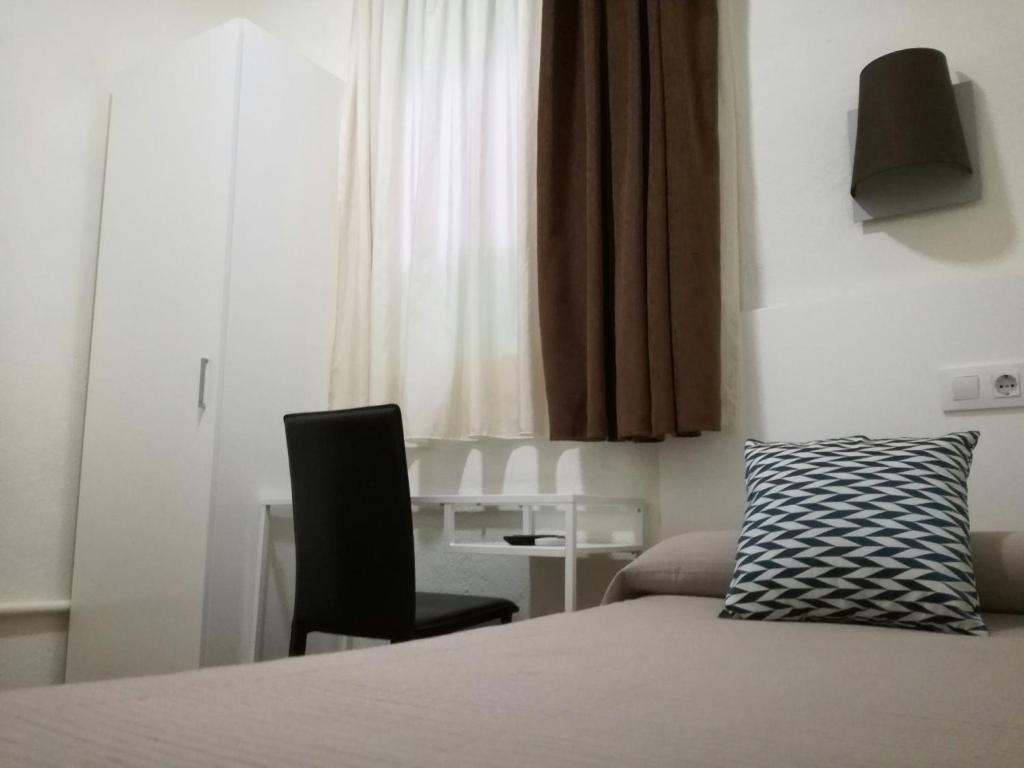 Posteľ alebo postele v izbe v ubytovaní Hostal Lesseps