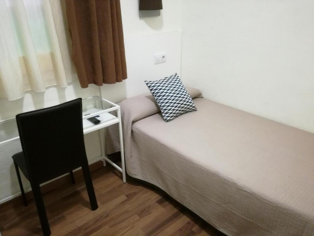Posteľ alebo postele v izbe v ubytovaní Hostal Lesseps