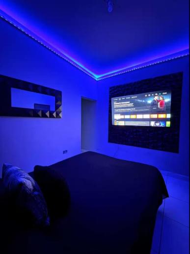 a blue room with a bed and a tv at Feng tower in Culiacán