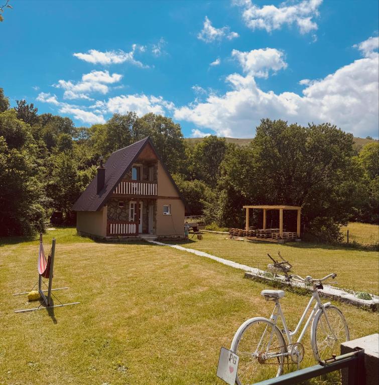 a house with a bike parked in front of it at Cottage Bellis in Pošćenje