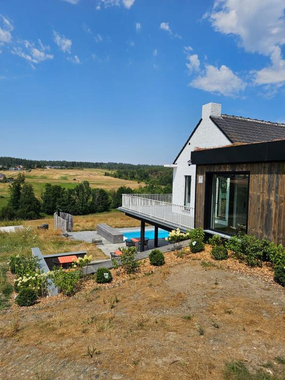 a house with a deck and a swimming pool at Les Terrasses de Laloux in Rochefort