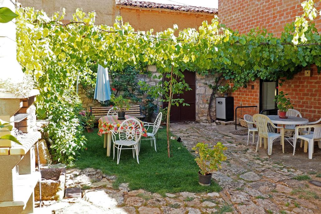 a patio with a table and chairs and an umbrella at Casa Rural Lutia in Andaluz