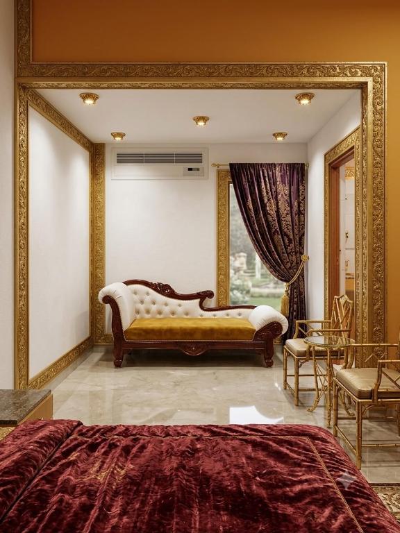 a bedroom with a couch and a large mirror at Hotel Coral Shade's in Mahabalipuram