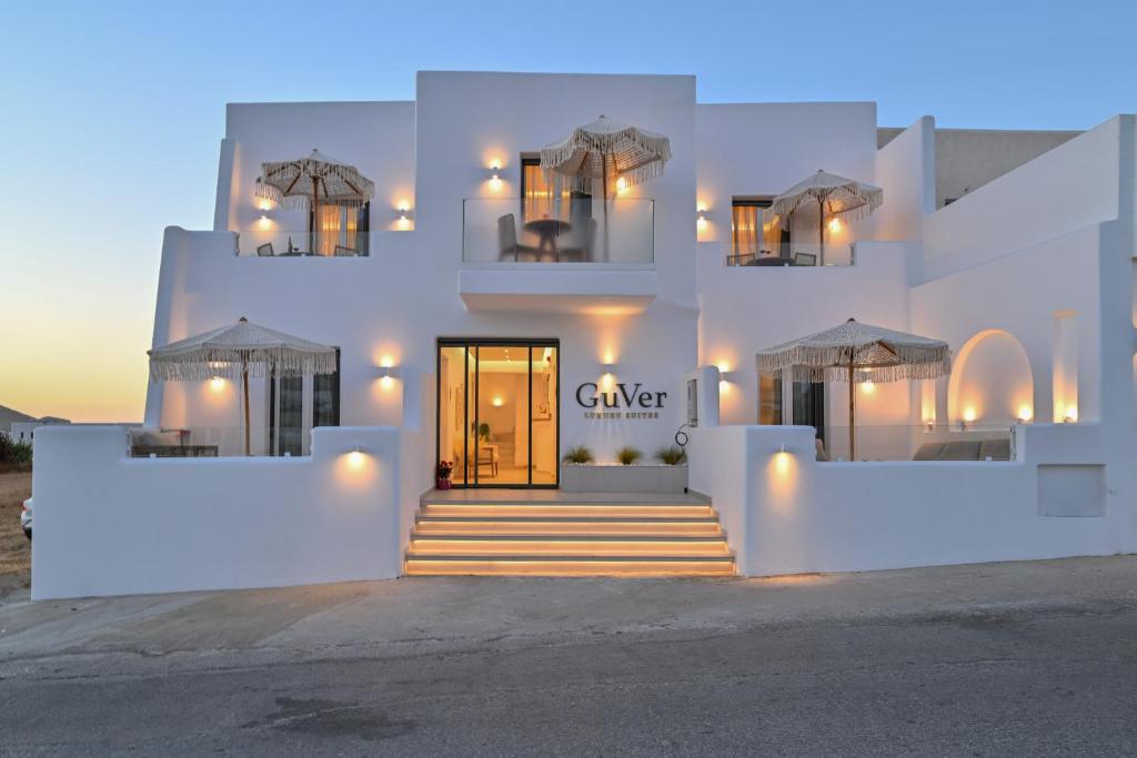 a white building with a front door at dusk at GuVer Luxury Suites in Agia Anna Naxos