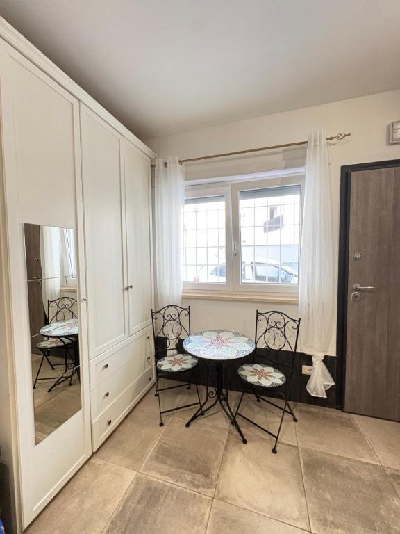 a dining room with two chairs and a table at Bassa Marea in Nettuno