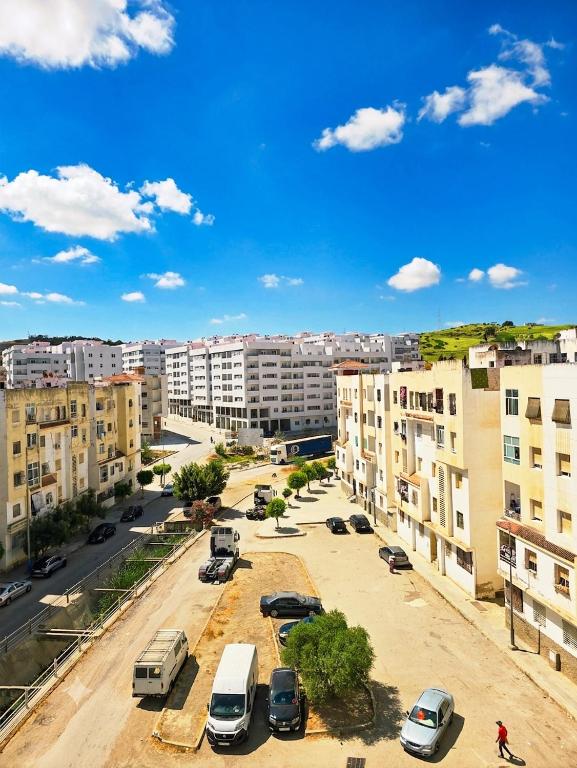 a city with cars parked in a parking lot at Morjan apart in Tangier
