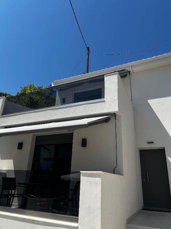 a building with a large window on the side of it at Tsonas Maisonette in Lygia