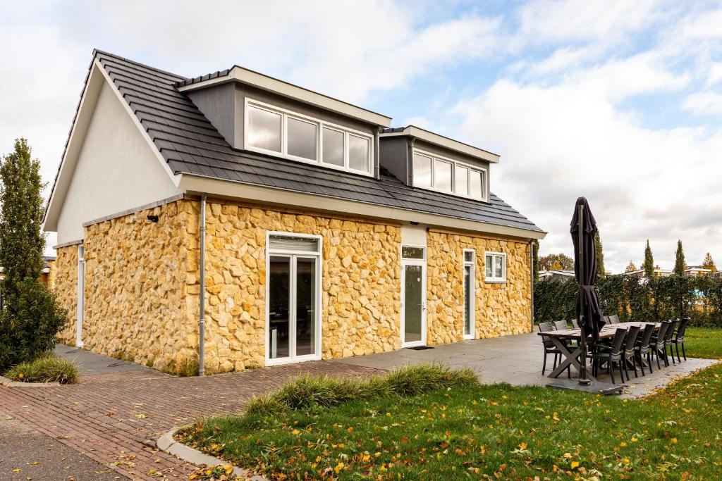 a stone house with a black roof at Group accommodation 123 in Valkenburg