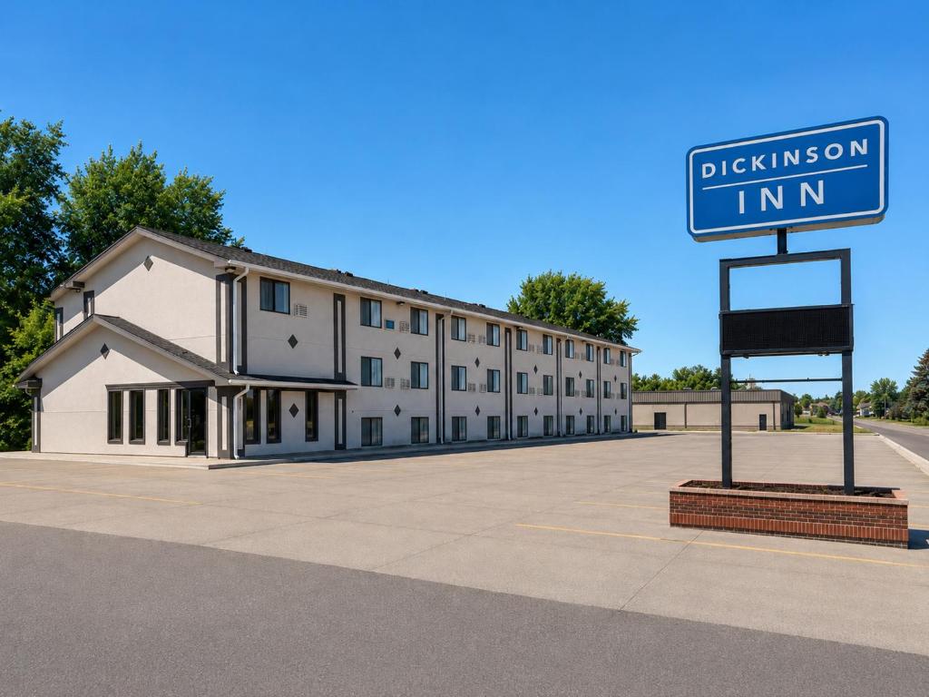 a building with a street sign in front of it at Dickinson Inn in Dickinson