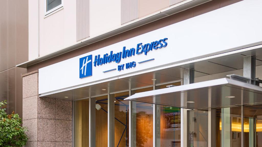 a building with a sign on the side of it at Holiday Inn Express Sapporo Susukino by IHG in Sapporo