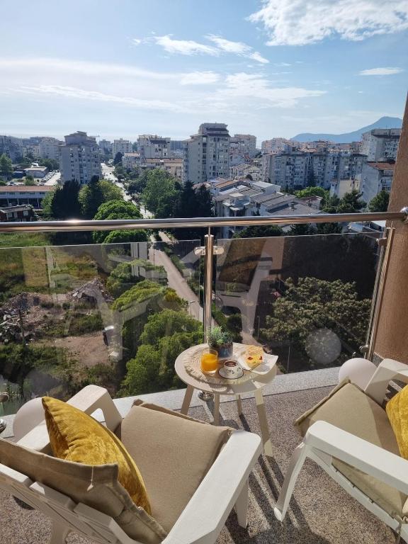 a balcony with a table and chairs and a view at Sea you in Bar in Bjeliši