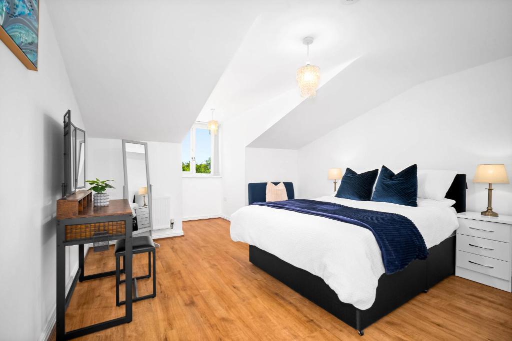 a bedroom with a bed and a desk and a tv at Providence Suites 1 Bedroom Sleeps 4 Perfect for Contractors and Families and Solo Travellers in Fallings Park