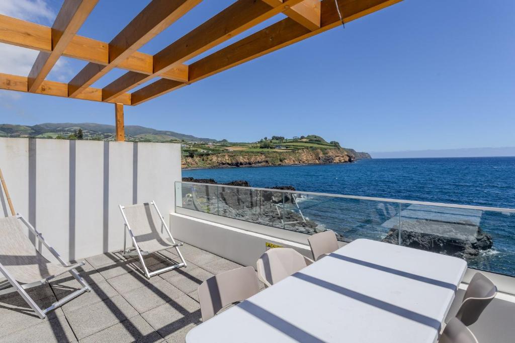 a balcony with chairs and a view of the ocean at GuestReady - Tranquil Oasis in Lagoa in Lagoa