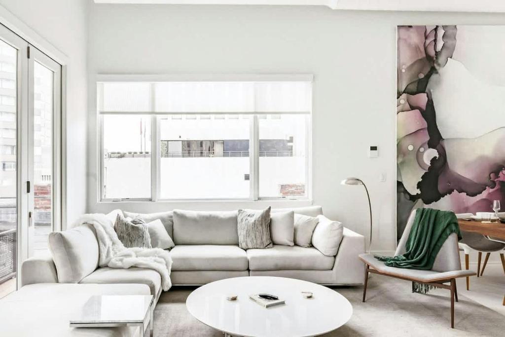 a living room with a couch and a table at Rooftop Condo in Nashville