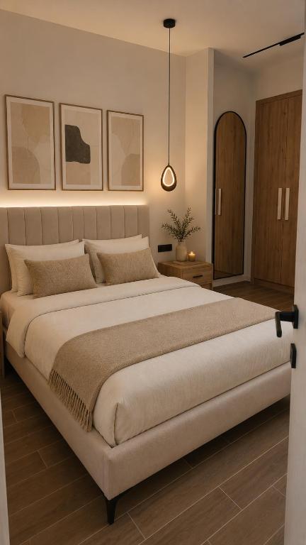 a bedroom with a large bed and a pendant light at Noema City View in Xanthi