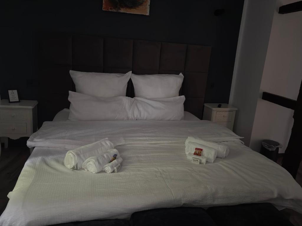 a bed with two packs of towels on it at Hotel Zur Krone in Nordwalde