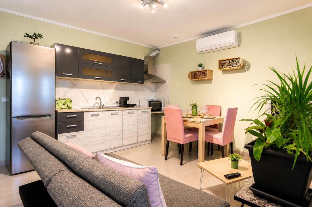 a kitchen and living room with a couch and a table at Goldtown House in Chrysoupolis
