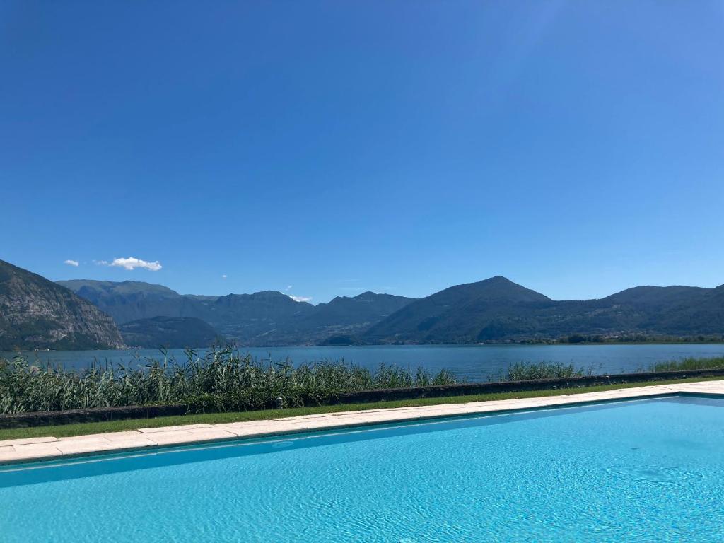a swimming pool with a view of a lake at franciacorta iseo lake house in Clusane sul Lago