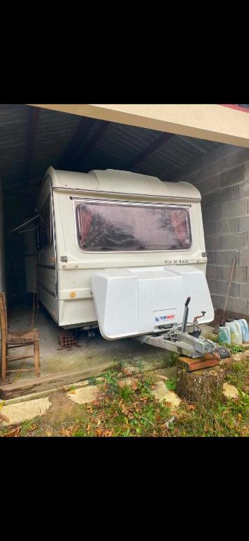 a white truck parked next to a brick wall at Camp pey in Saubion
