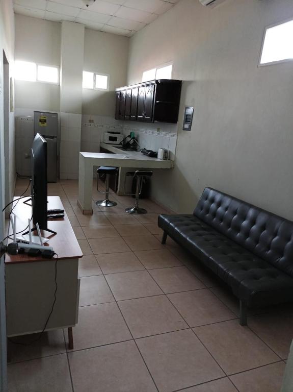 an office with a couch and a desk with a computer at EdificioSsur 0601 in Choluteca