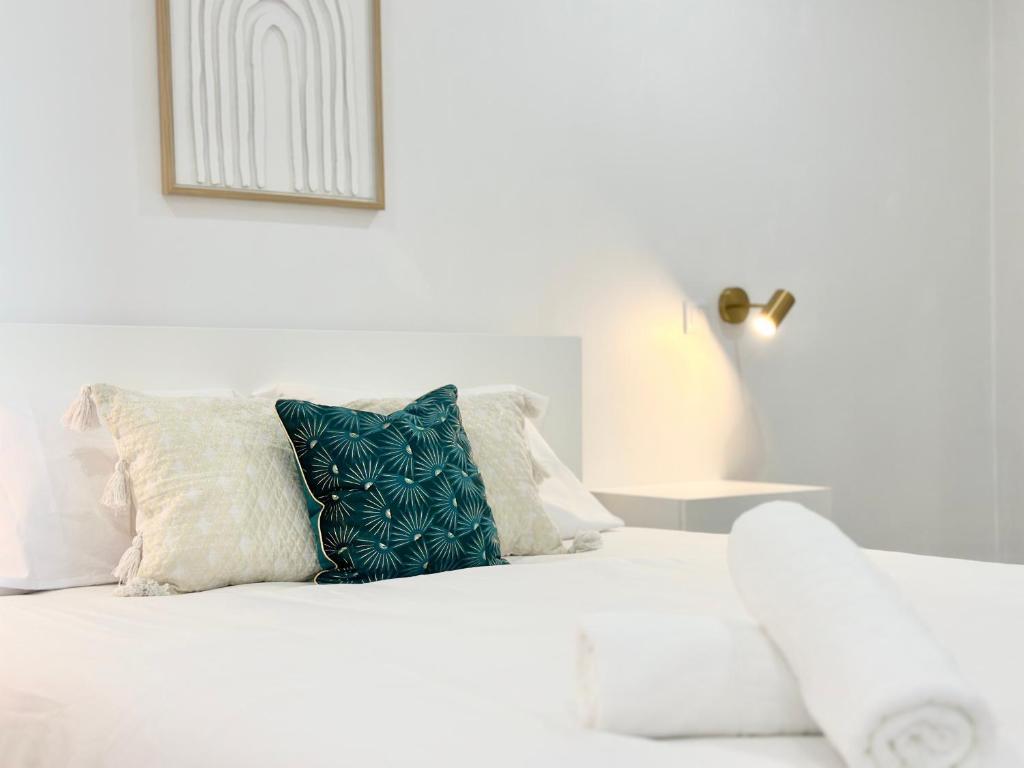 a white bed with pillows on top of it at Waves Madeira II in Caniçal