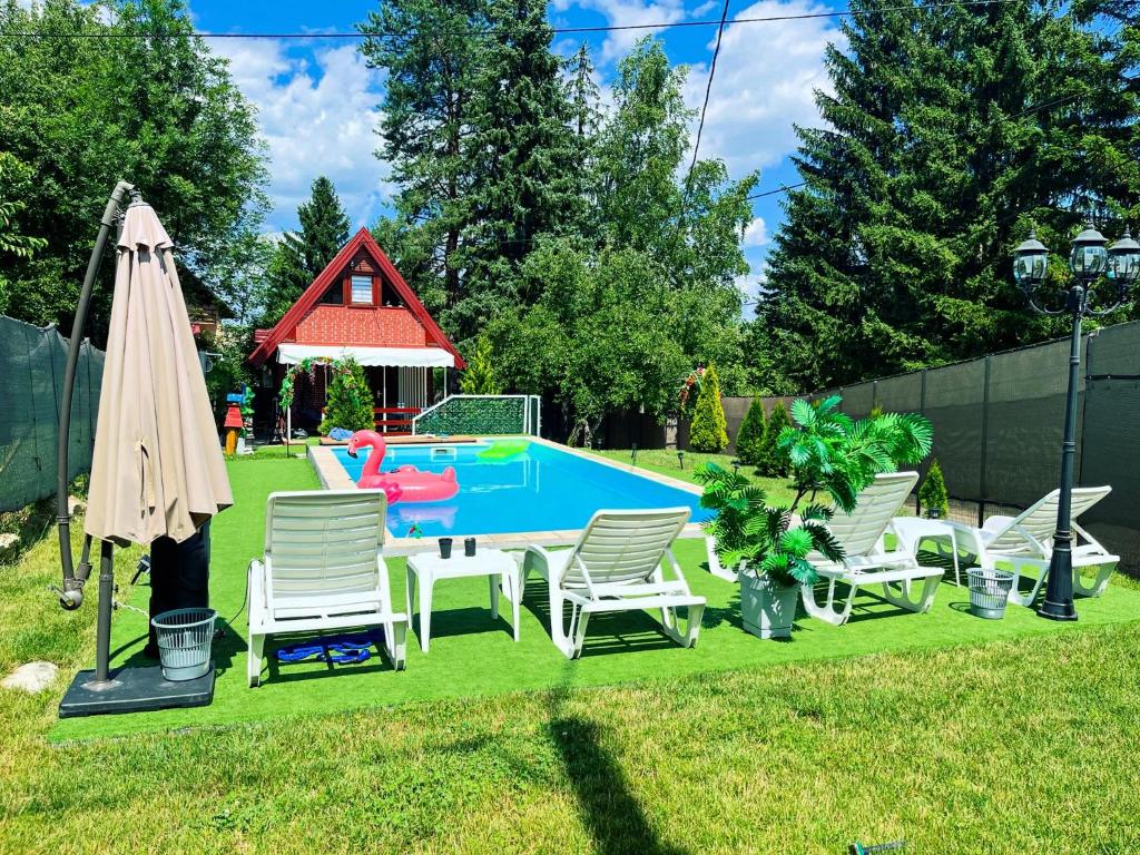a group of chairs and a pool in a yard at Kuća za odmor sa bazenom Aria in Potkraj