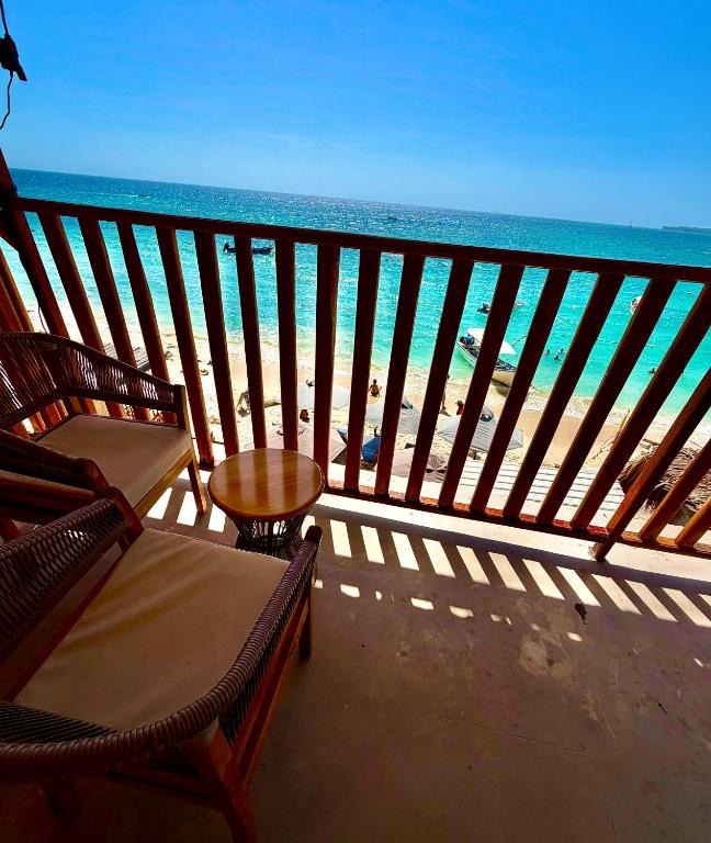 a balcony with chairs and a view of the ocean at Cabañas W Beach in Cartagena de Indias