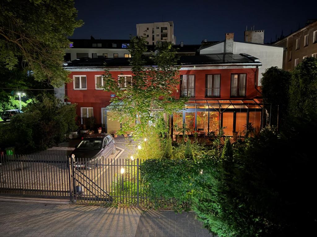 a house with a gate in front of a building at Szmulson in Warsaw