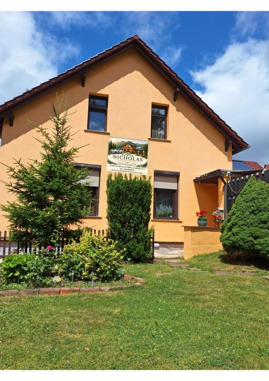 a house with a sign on the side of it at Nicholas Apartment-Thuringer Wald in Tambach-Dietharz