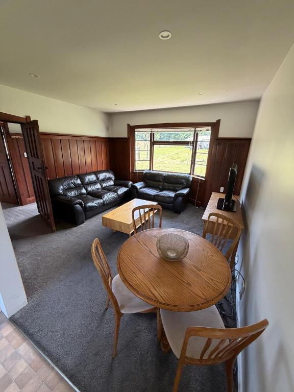 a living room with a table and a couch at Green Views - Burkes Pass in Burkes Pass