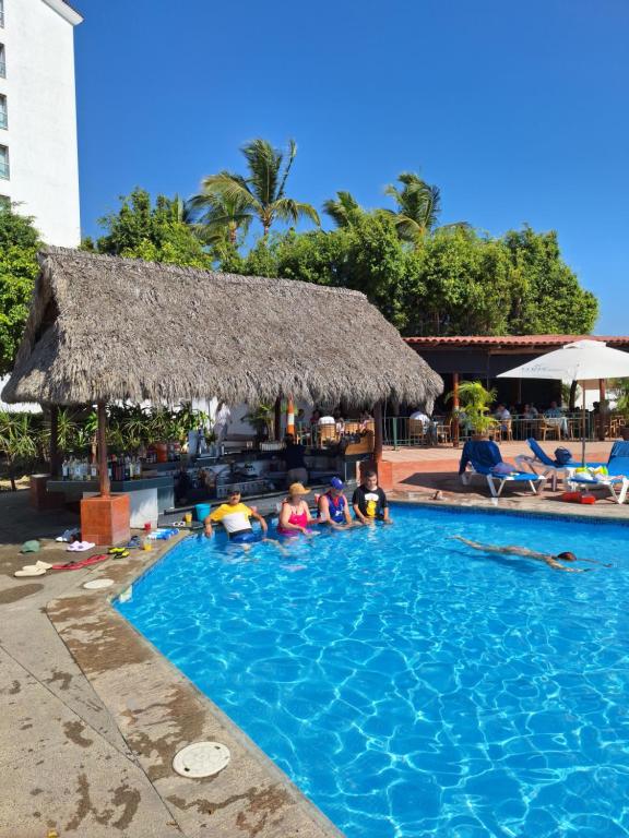 a group of people sitting in a swimming pool at Depa en planta baja con alberca in Puerto Vallarta