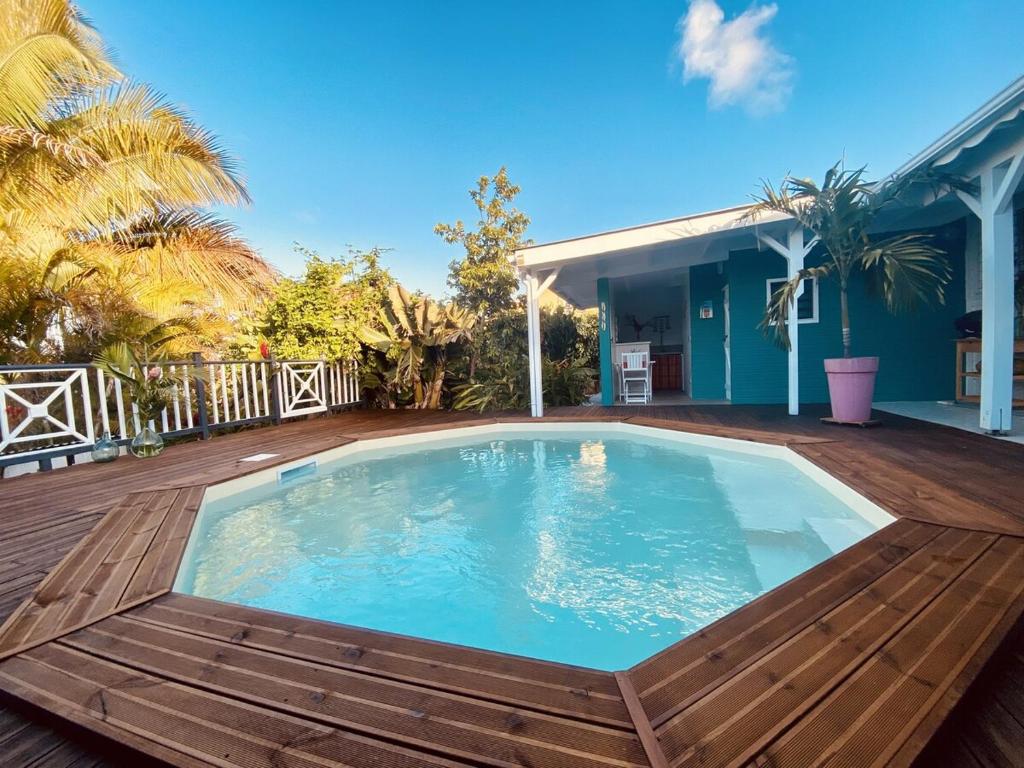 a large swimming pool on a wooden deck at Papaye et coconut in Anse-Bertrand