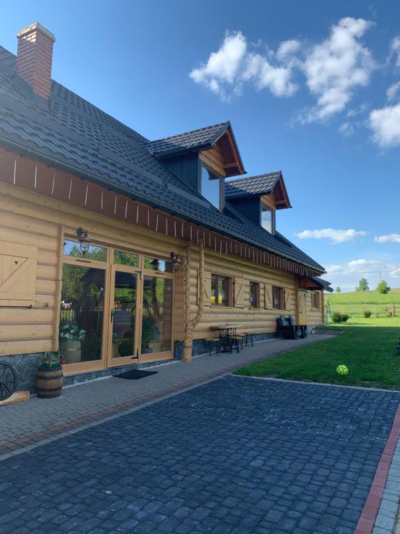 a log home with a gambrel roof at Na Snozie in Milówka