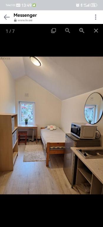a bedroom with a bed and a table and a mirror at Korter in Tartu