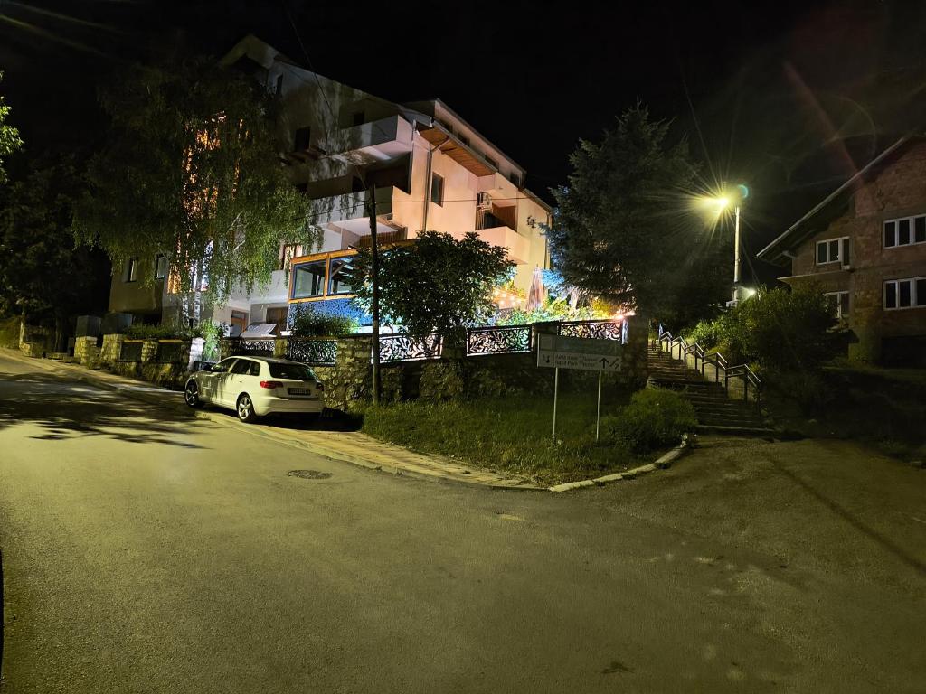a car parked on the side of a street at night at APARTMANSKI SMEŠTAJ SOLARIS kod Aqua Parka SUPERIOR & FAMILY Apartments in Soko Banja