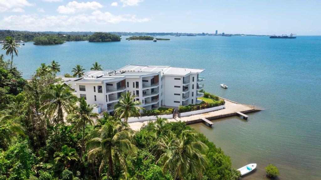 an aerial view of a large white building on the water at 201 - Ocean Views Oceanfront Large Balcony in Suva